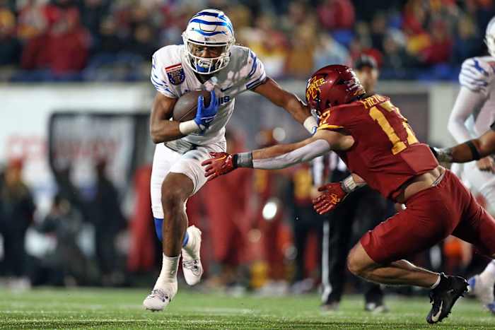 Dec 29, 2023; Memphis, TN, USA; Memphis Tigers running back Blake Watson (4) runs the ball as Iowa State Cyclones defensive back Beau Freyler (17) makes the tackle during the second half at Simmons Bank Liberty Stadium. Mandatory Credit: Petre Thomas-USA TODAY Sports  